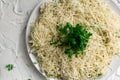 Layered salad with grated hard cheese with lettuce leaves and watercress greens on a white concrete background