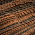 Layered sandstone formations with alternating shades of reddish-brown and b Royalty Free Stock Photo