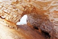 Layered sandstone rock cave with view of ocean