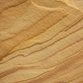 Layered sandstone texture with parallel lines in shades of beige and brown. The surfa Royalty Free Stock Photo