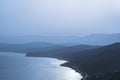 Layered silhouettes of mountains in a blue haze at dawn or sunset. Beautiful natural landscape Royalty Free Stock Photo