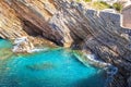 Layered stones and turquoise sea in Petrovac village