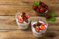 Layered strawberries cream cheese dessert on wooden background Royalty Free Stock Photo