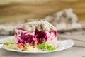 layered vegetable salad with beets and herring, on a wooden table Royalty Free Stock Photo