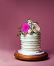 layered wedding cake with roses and cream on neutral background AI, minimalist style, tone on tone colors Royalty Free Stock Photo