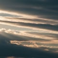Layers of clouds streak across the sky, displaying a mix of dark, shadowed sections Royalty Free Stock Photo