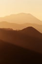 Layers of hills and mountains in beautiful radiant light of setting sun Royalty Free Stock Photo