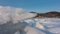 Layers of icy snow lie in disarray on a frozen lake. Royalty Free Stock Photo