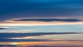 Striking Lenticular Clouds Illuminated by Soft Sunset Light Against a Deep Blue Sky Royalty Free Stock Photo