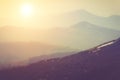 Layers of mountain and haze in the valleys. Fantastic evening glowing by sunlight. Royalty Free Stock Photo