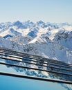 Layers of mountain peaks reflected on glass - view from Parpaner Rothorn upper cable station in Arosa Lenzerheide resort.