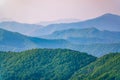 Layers of mountains in the haze during sunset. Beautiful sunset in the hills and mountains. Beautiful sunset in a hilly valley Royalty Free Stock Photo