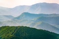 Layers of mountains in the haze during sunset. Beautiful sunset in the hills and mountains. Beautiful sunset in a hilly valley Royalty Free Stock Photo