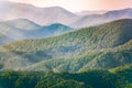 Layers of mountains in the haze during sunset. Beautiful sunset in the hills and mountains. Beautiful sunset in a hilly valley Royalty Free Stock Photo