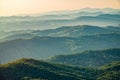 Layers of mountains in the haze during sunset. Beautiful sunset in the mountains. Beautiful sunset in a hilly valley with villages Royalty Free Stock Photo