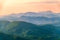 Layers of mountains in the haze during sunset. Beautiful sunset in the hills and mountains. Beautiful sunset in a hilly valley Royalty Free Stock Photo