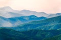 Layers of mountains in the haze during sunset. Beautiful sunset in the hills and mountains. Beautiful sunset in a hilly valley Royalty Free Stock Photo