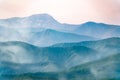 Layers of mountains in the haze during sunset. Beautiful sunset in the hills and mountains. Beautiful sunset in a hilly valley Royalty Free Stock Photo