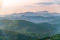 Layers of mountains in the haze during sunset. Beautiful sunset in the hills and mountains. Beautiful sunset in a hilly valley Royalty Free Stock Photo