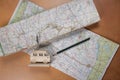 Layflat travel themed background of road maps and pencil Royalty Free Stock Photo