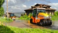 Laying asphalt during rain. Roadwork