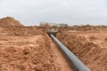 Laying drain pipes and concrete manholes for stormwater system. Connecting a trench drain to a concrete manhole