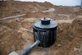 Laying drain pipes and concrete manholes for stormwater system. Connecting a trench drain to a concrete manhole