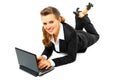 Laying on floor business woman using laptop Royalty Free Stock Photo