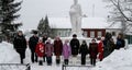 Laying flowers and funeral wreaths at a mass grave in the Kaluga region in Russia.