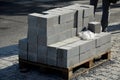 Laying granite and marble light, white gray, medium size cubes. tilers put cobblestones in sand or gravel. they have piles ready