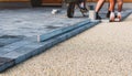 Laying gray concrete paving slabs in house courtyard driveway pa Royalty Free Stock Photo