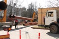 Laying heating pipes with a crane. Construction work in the city. Installation of underground water supply and sewerage. Royalty Free Stock Photo