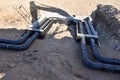 Laying heating pipes in a trench at construction site. Install underground storm systems of water main and sanitary sewer. Cold Royalty Free Stock Photo