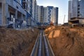 Laying heating pipes in a trench at construction site. Install underground storm systems of water main and sanitary sewer. Cold Royalty Free Stock Photo