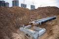 Laying heating pipes in a trench at construction site. Installation underground storm sewer pipes of water main and sanitary sewer Royalty Free Stock Photo