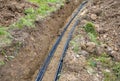 Laying high voltage cables to the ground. the environment does not damage electric poles. Excavation meter deep in the ground blac