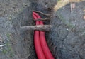 Laying high voltage cables to the ground. the environment does not damage electric poles. Excavation meter deep in the ground red
