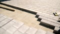 Laying interlocking pavers during patio construction Royalty Free Stock Photo