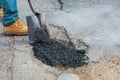 Laying new asphalt, covering the pit, very bad quality road with hole in asphalt Royalty Free Stock Photo