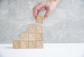 Laying out by hand steps of wooden cubes leading top.Concept growth and development business. Royalty Free Stock Photo