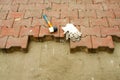 Laying Paving Slabs by mosaic close-up. Road Paving, construction. Workers laying stone paving slab. Laying colored Royalty Free Stock Photo