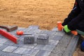 Laying paving stones.