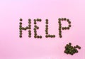 Word `help` made from green pills on a white background Royalty Free Stock Photo