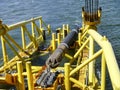 Laying of pipes with pipe-laying barge crane near the shore. Descent of the pipeline to a bottom exhausting with the pipelaying ba Royalty Free Stock Photo