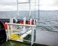 Laying of pipes with pipe-laying barge crane near the shore. Descent of the pipeline to a bottom exhausting with the pipelaying ba