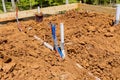 Laying sanitary pvc sewage pipes and water pipe system in trench Royalty Free Stock Photo