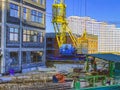 Laying sewer wells and pipes of the heating syste at construction site. Tower cranes in action. Formworks and pouring concrete thr Royalty Free Stock Photo