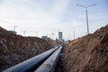 Laying of underground storm sewer pipes at the construction site. Installation of water main and sanitary sewer on background