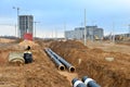 Laying underground storm sewers at a construction site. Groundwater system for new residential buildings in the city. Installation