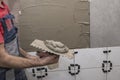 Installing ceramic wall tiles with tile levelers Royalty Free Stock Photo
